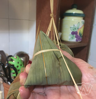 Wrapping, shaping and tying up the Bak Chang with bamboo string 