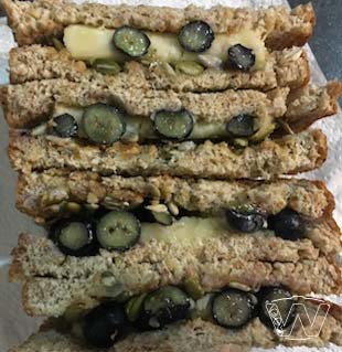 Side view of cut stack of wholemeal sandwich showing banana and blueberry