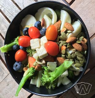 Salad bowl of Hardboiled Egg Broccoli Cherry Tomato Almond nuts and Pumpkin seeds