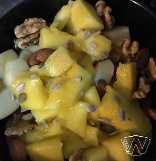 Bowl of Mango salad with Walnuts, Almond nuts