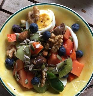 Salad bowl of Papaya Kiwi Blue Berry Hardboiled Egg