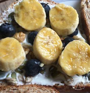 100% wholegrain Sunshine bread spread with Yogurt with banana slices walnuts pumpkin seeds and blueberry toppings